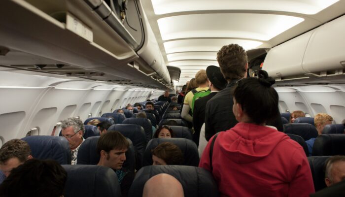 Source: https://unsplash.com/photos/group-of-people-in-airliner-XHwTbPKn4mE